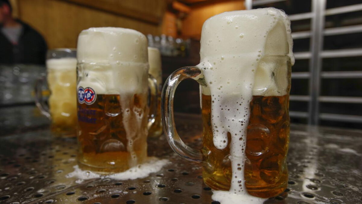 Why do bartenders wet the glass before serving the beer?