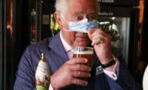 Prince Charles takes a sneaky sip of beer while visiting local businesses