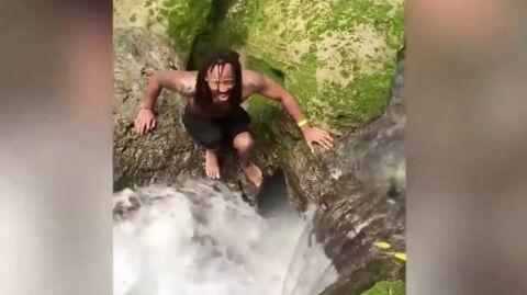 Watch as these two tourists jump into a waterfall and disappear into the jungle