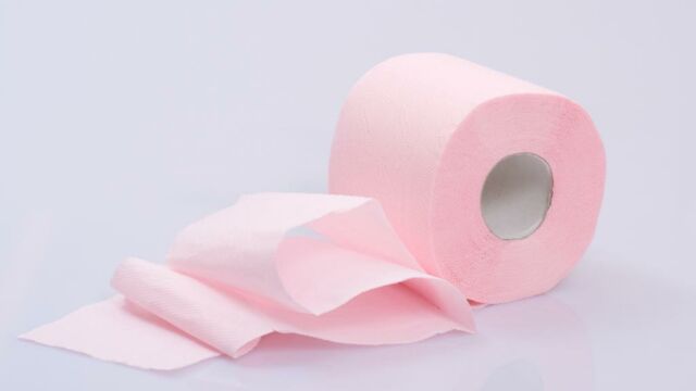 roll pink toilet paper, a roll of pink toilet paper on a white