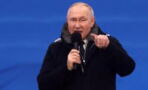 Vladimir Putin: Russian citizens were reportedly bribed to attend rally marking anniversary of war
