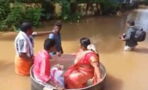 India floods: Couple sail to their wedding in a cooking pot