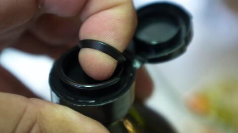 People shocked to learn the actual use for plastic pull tab on oil bottles