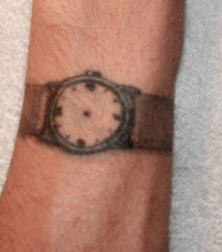 A watch with no hands: this tattoo means the prisoner has received a life sentence, hence the time on the clock not mattering.