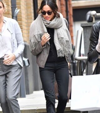 3. Meghan was spotted shopping in London wearing a long scarf, grey jacket, black jeans, and boots. The grey coat is from LINE and costs about £520.