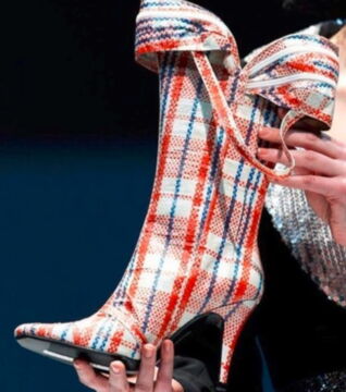 High heel boots that look like a shopping bag. Who would ever buy that? There's even a strap and a zipper where you can store things in.