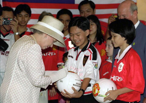 Queen Elizabeth signing an autograph
