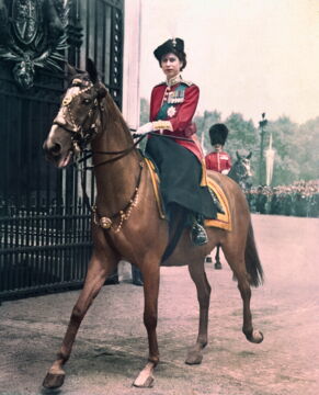 The Queen returning to Buckingham Palace on horseback in 1963 after attending the Trooping the Colour ceremony.