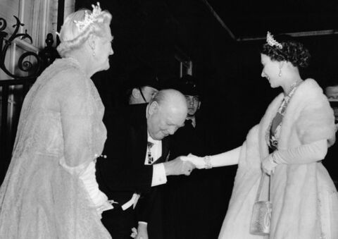 Then Prime Minister, Winston Churchill greets Queen Elizabeth as she attends a dinner at Downing Street in 1955.